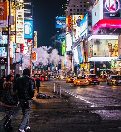 Times Square at night with taxis and billboards